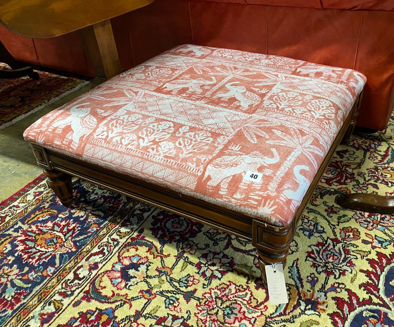 A reproduction Victorian style mahogany footstool upholstered in Jane Churchill 'Elephant Parade' fabric, length 66cm, depth 68cm, height 26cm